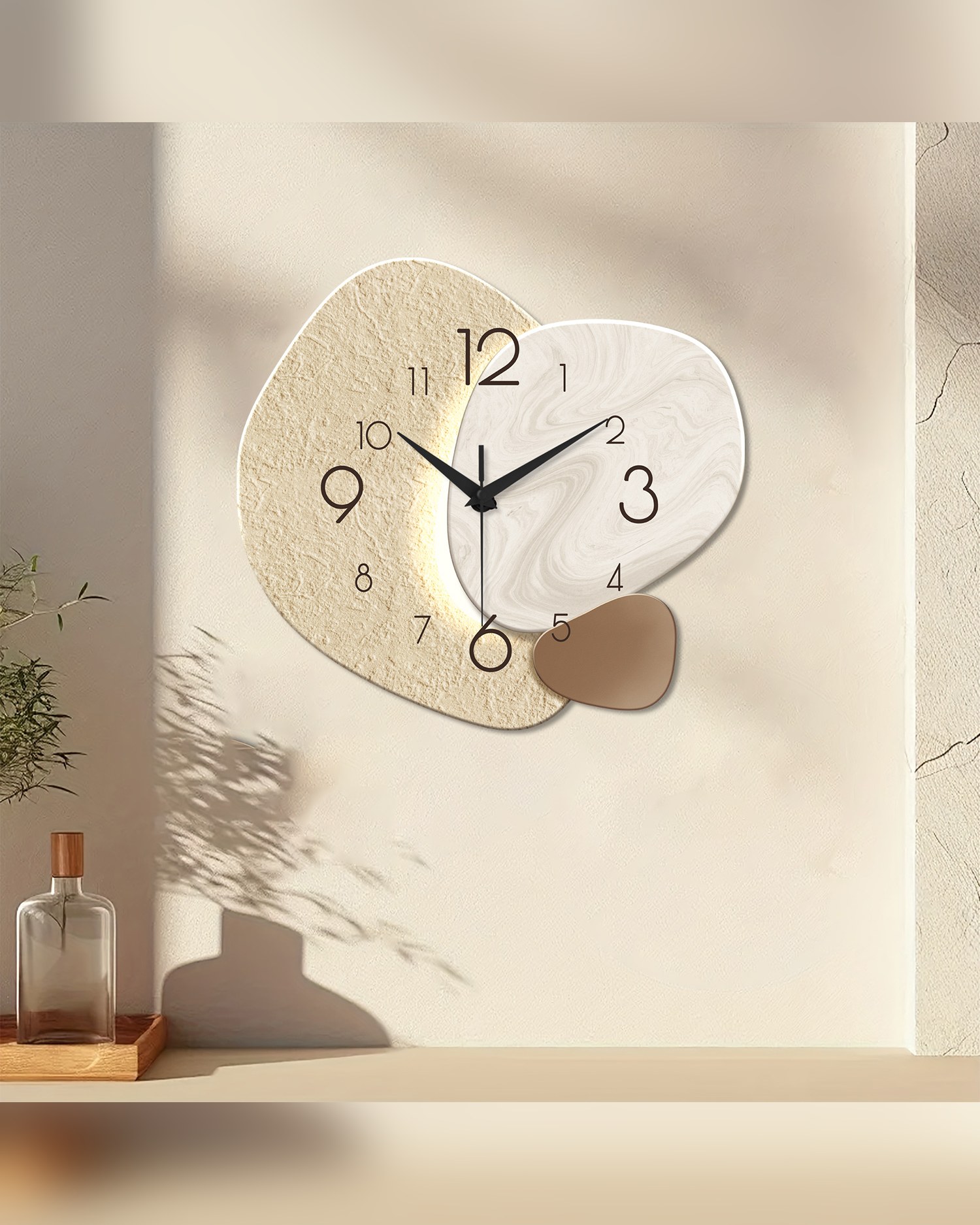 Organic pebble-shaped wall clock in alabaster, hung on a pale wall