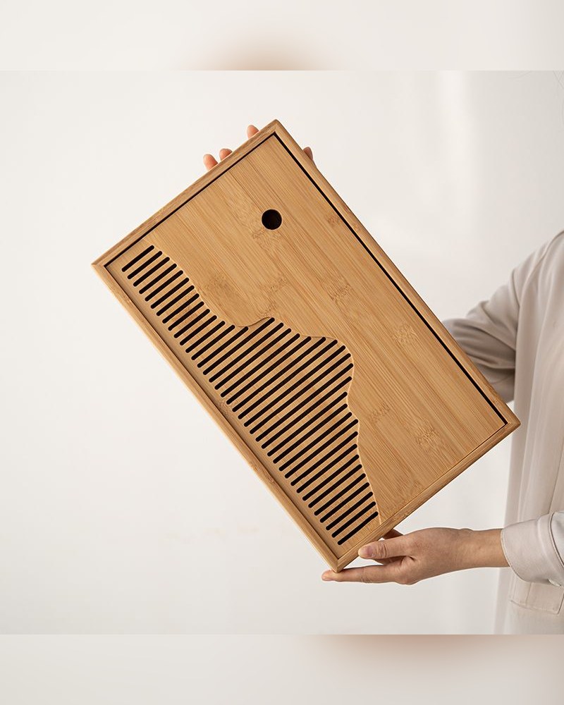 Bamboo tea tray with a slatted drainage bed and a carved ridge edge