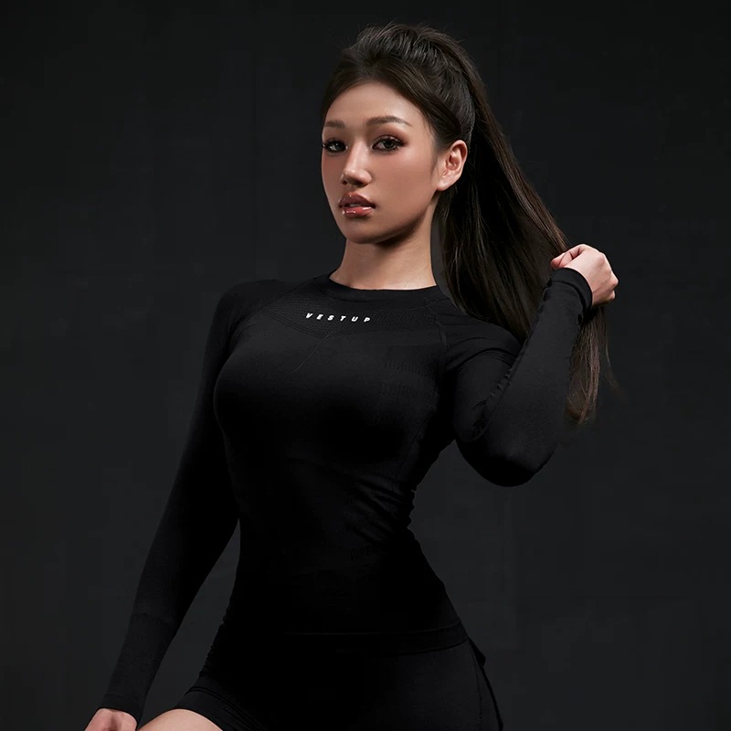 Seamless long-sleeve training top in black, worn, zoned knit across the chest