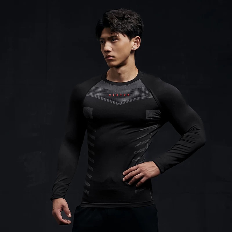 Seamless long-sleeve training top in black grey, worn, zoned knit panels